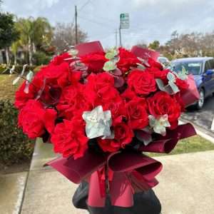 Classic luxury red rose bouquet with burgundy wrapping paper